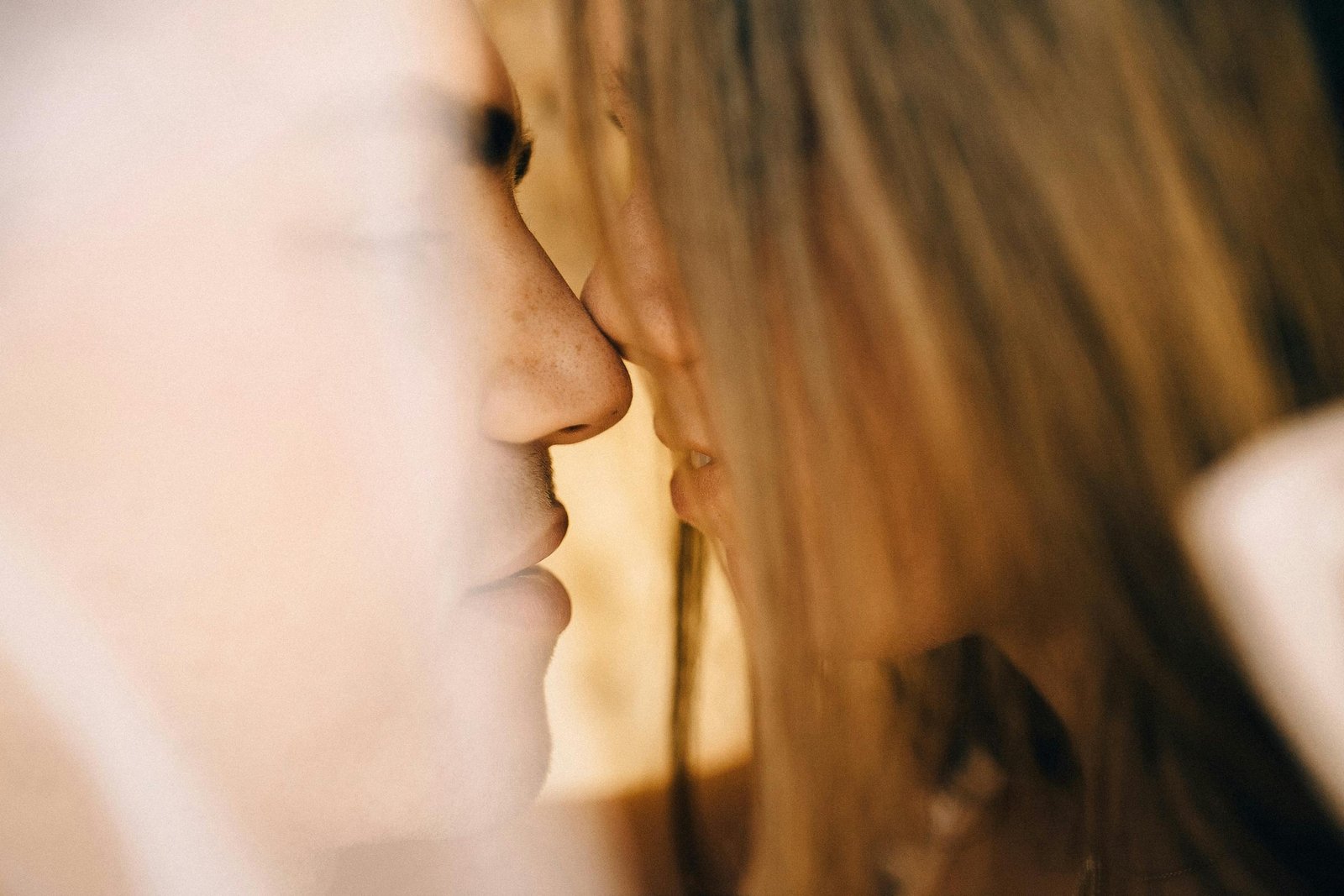 Soft focused intimate moment of a couple in a romantic setting, evoking love and connection.